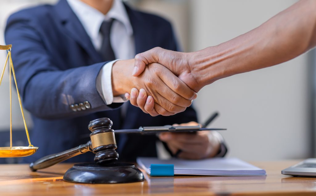 business handshake with legal scale and gavel 2026 01 08 02 41 03 utc